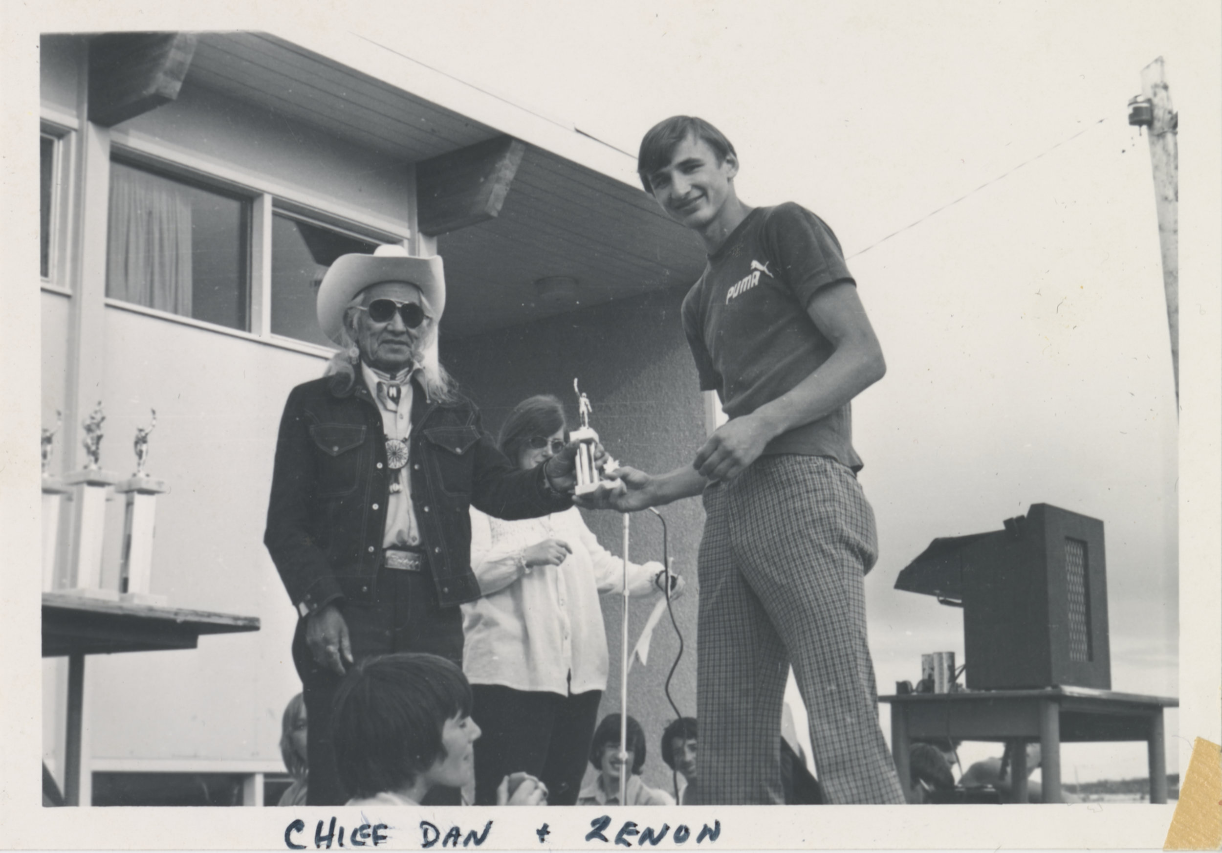 Image shows Chief Dan George presenting Zenon Smiechowski with an Outstanding Athlete award. Photo is taken at the Fort St. John Invitational Track Meet in June 1973.